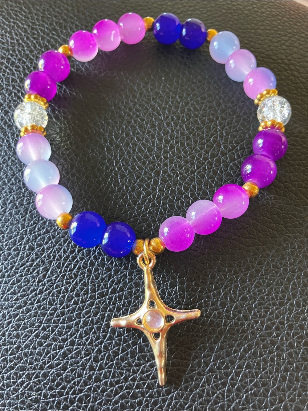 Purples and blues glass beaded bracelet with gold accent and North Star charm